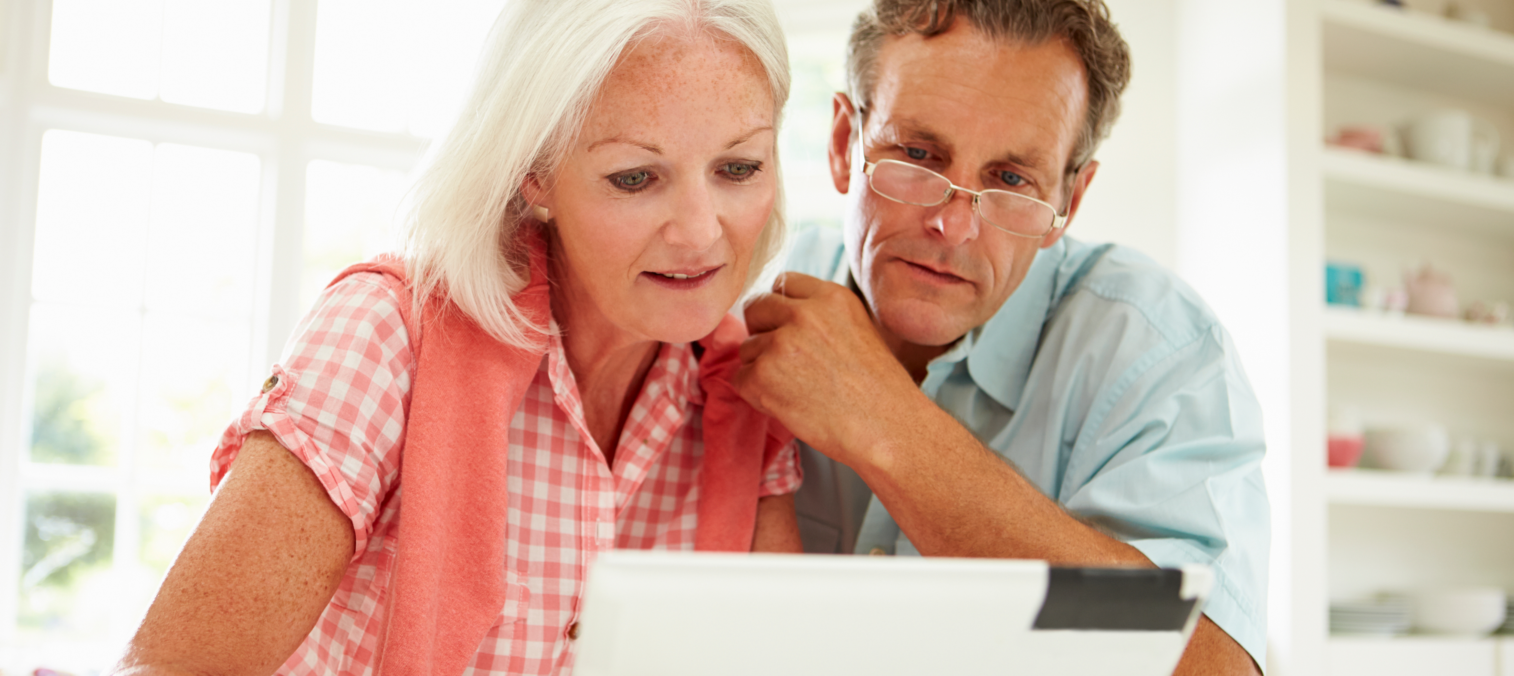Two Middle Aged Looking at Laptop Two Middle Aged Looking at Laptop