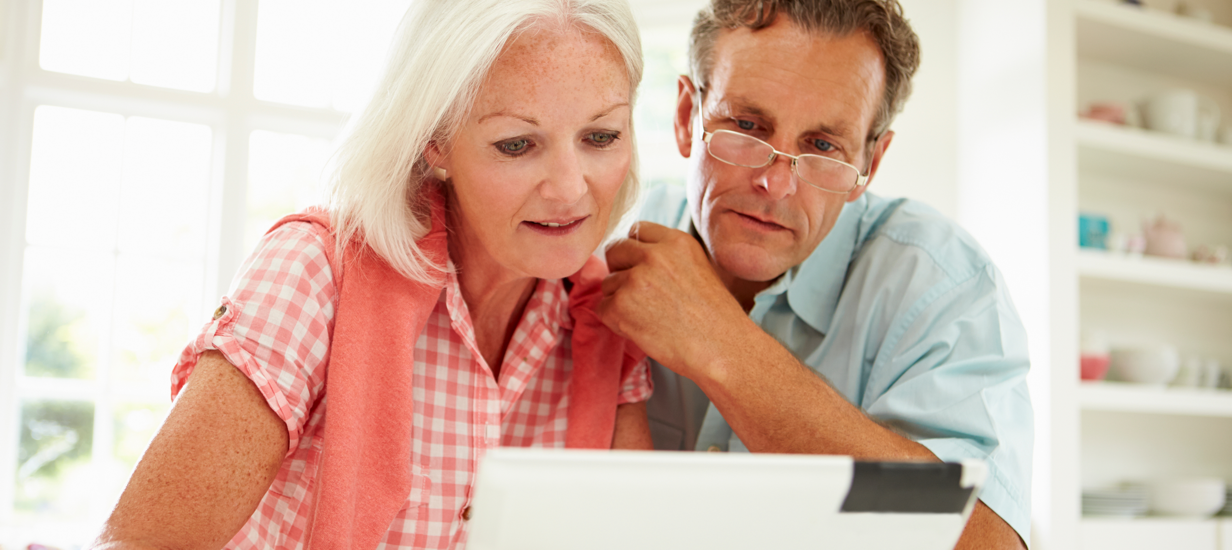 Two Middle Aged Looking at Laptop